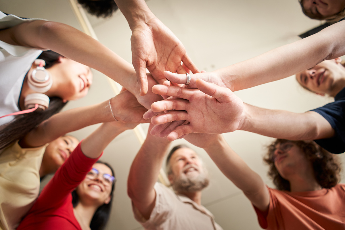 Cooperative Students and Teacher Joining Hands 